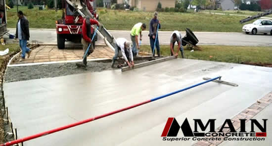 Concrete Driveway Installation with Brick Strip